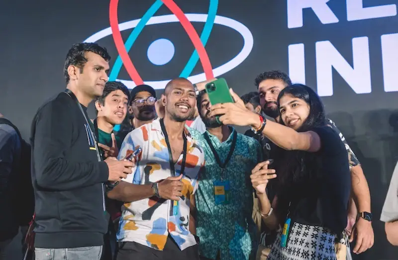 People taking a group selfie at React India